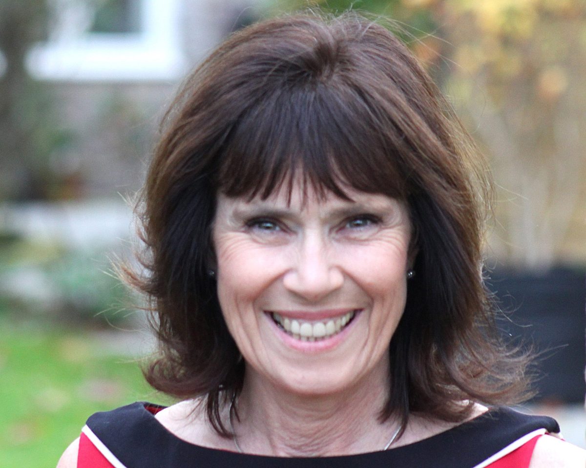 Smiling client with a dark layered bob