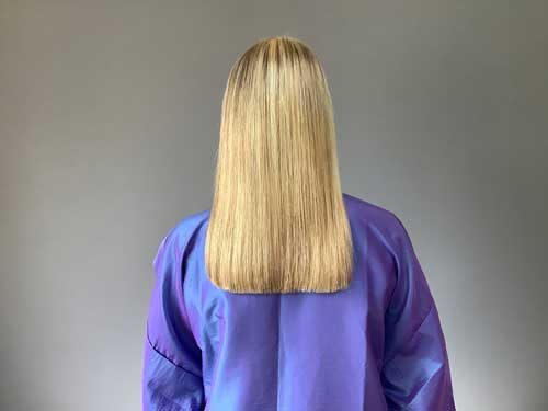 Long, straight blonde hair, back view